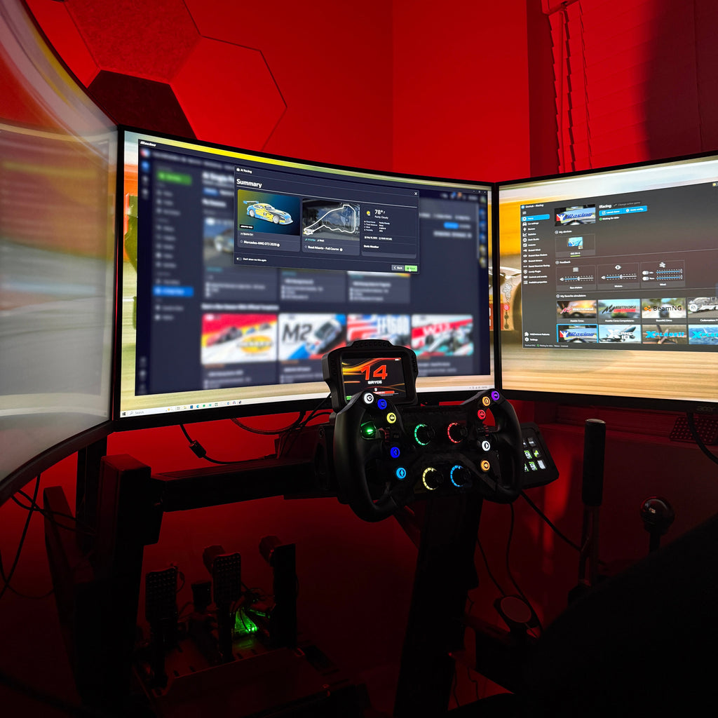 Gaming setup with dual monitors and a joystick on a red wall background